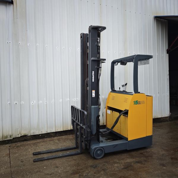 Used Komatsu electric reach stacker side view showing yellow frame and lifting mechanism