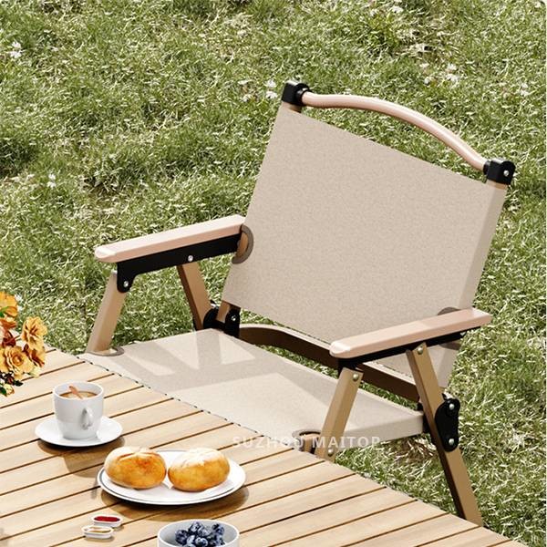 Black camping chair folded for transport