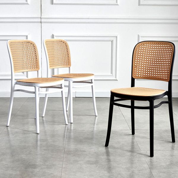 Side view of the dining chair showing rattan seat design
