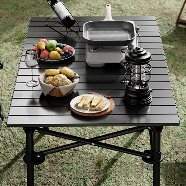 Small foldable camping table packed in carrying bag